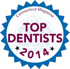 The image features a circular badge with text indicating it s an award from  Connecticut Magazine  for  Top Dentists 2014.  The badge includes a number  1  in the center, suggesting first place, and includes a graphic of a tooth with a crown.