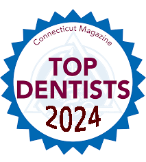 The image shows a badge with text that reads 'Top Dentists 2021' and includes a logo for Connecticut Magazine, indicating an achievement or recognition related to dental professionals in the year 2021.