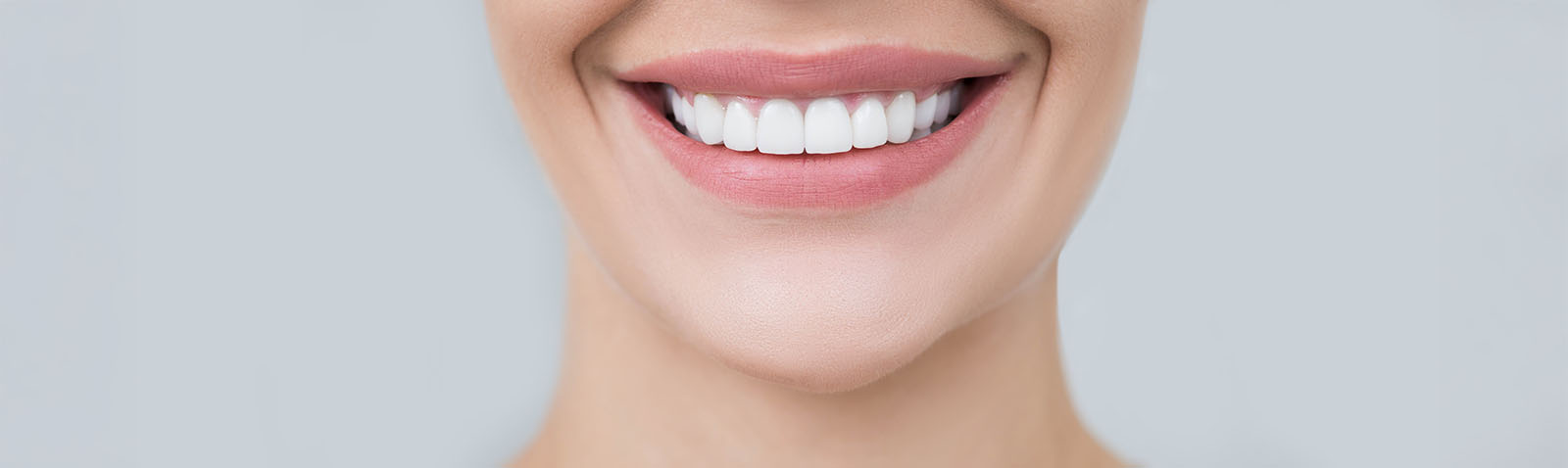 The image shows a person with a smiling expression, likely highlighting dental care products or services.
